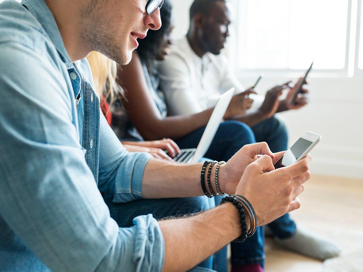 Four people on their mobile phones